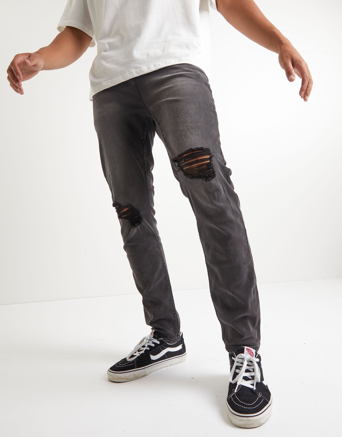 black ripped tapered jeans